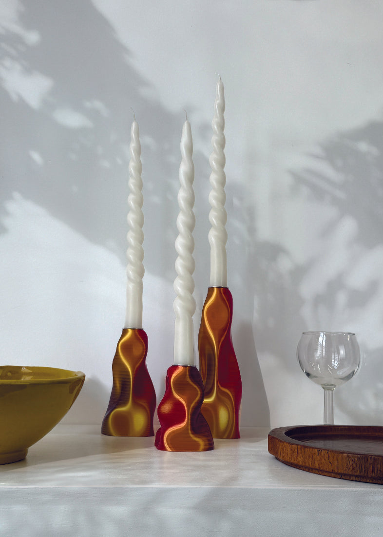 Decorative vases with wavy designs on a white surface with a light background