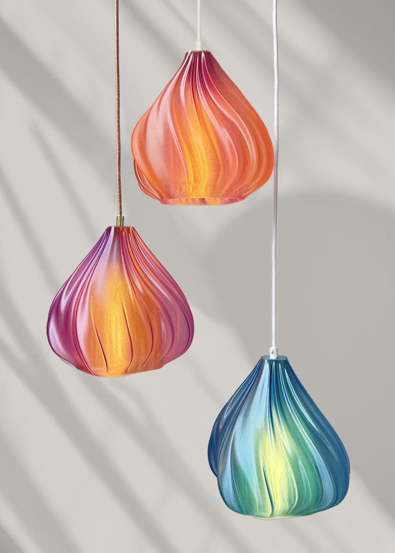 Colorful glass pendant lights on a neutral background