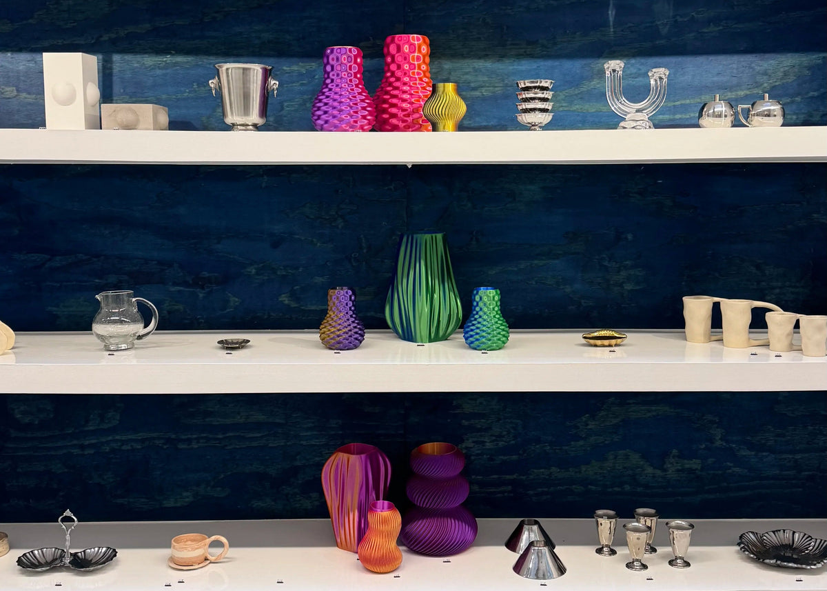 Shelves with various colorful decorative items against a blue wall