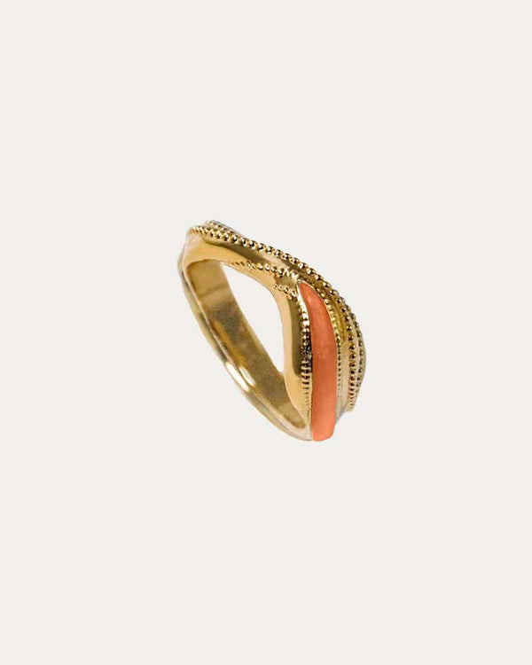 A gold-colored ring with intricate millegrain and enamel details, featuring a textured surface and a pointed shape on the top.